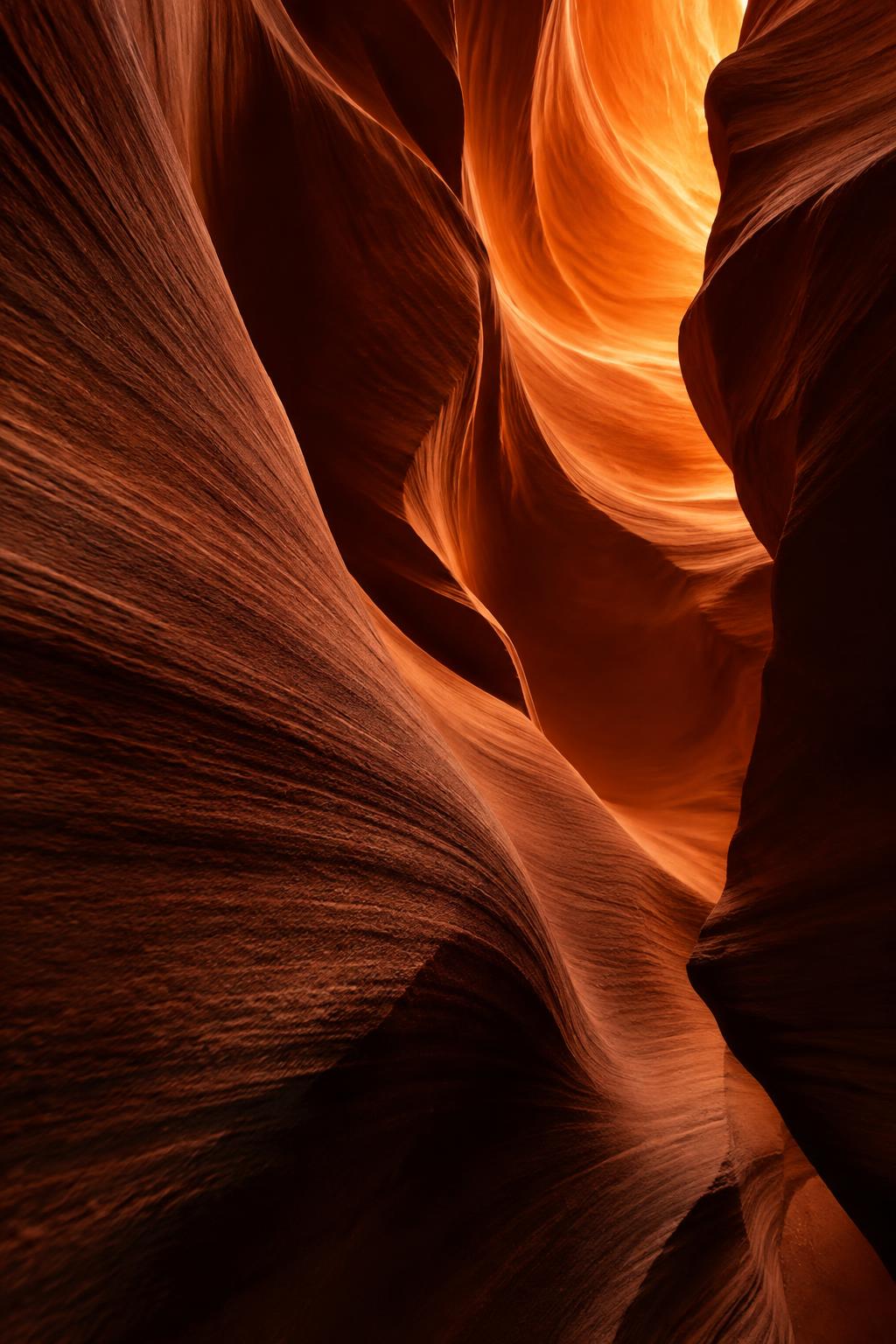 Sunlit sandstone canyon folds in deep terracotta shadow