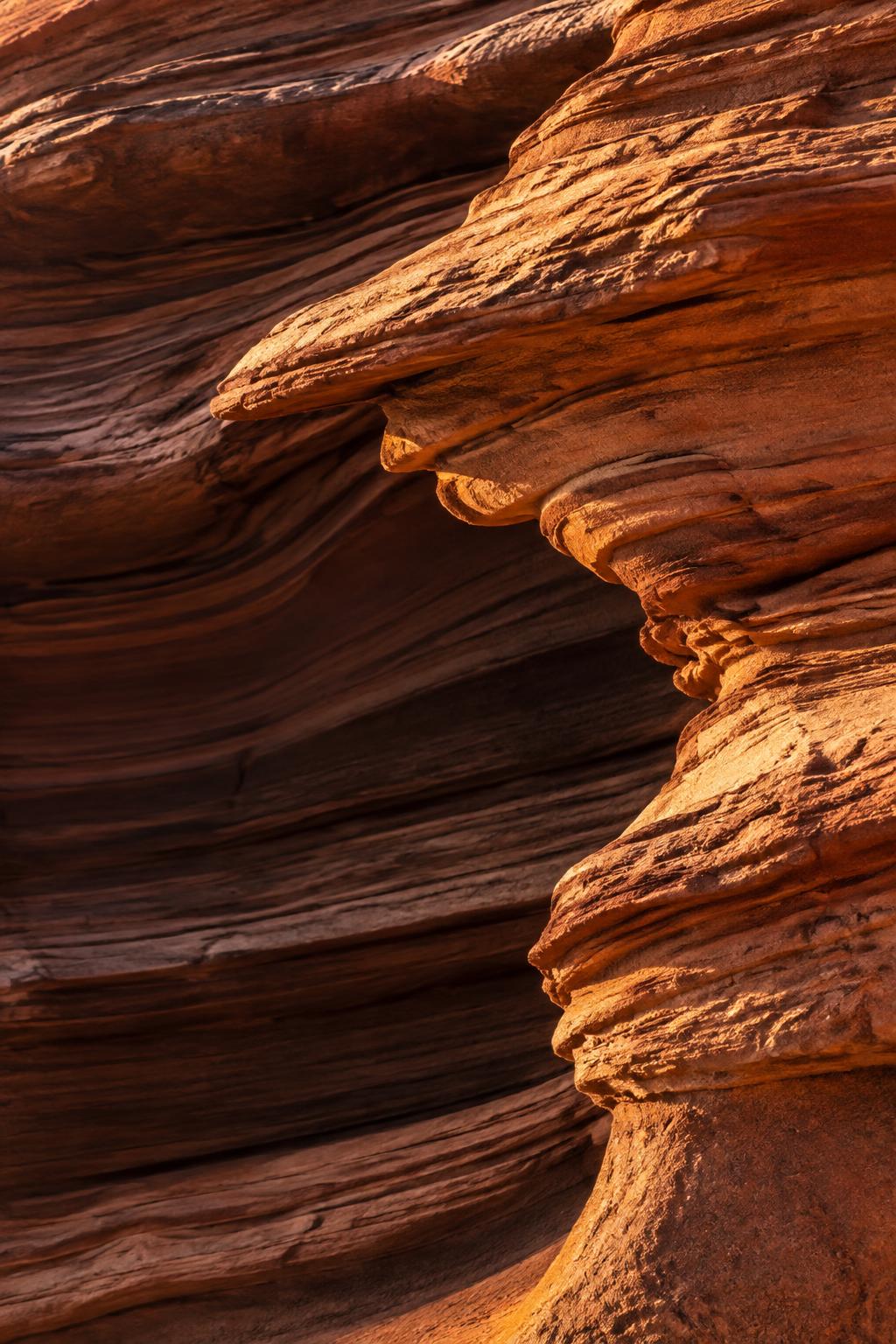 Warm copper sandstone ledges layered in raking light